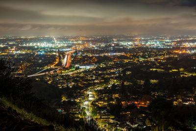 Aerial view of illuminated building in city against sky