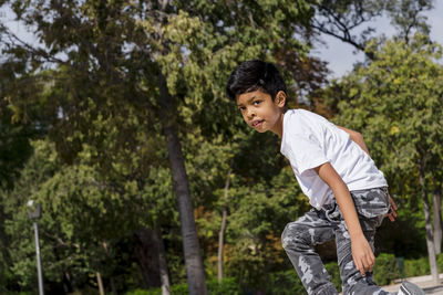 Young boy enjoying playing at the playground in the park.