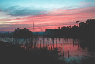 Scenic view of lake against sky at sunset