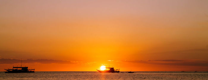 Scenic view of sea against orange sky