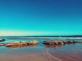 Scenic view of sea against clear blue sky