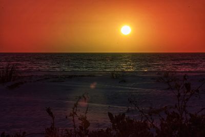 Scenic view of sea against orange sky