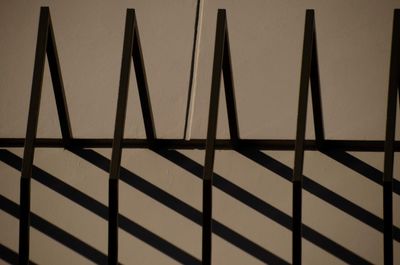 Silhouette fence against wall