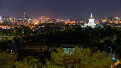 High angle view of illuminated buildings in city at night