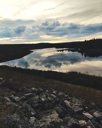 Scenic view of lake against sky at sunset