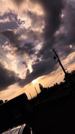 Low angle view of silhouette trees against sky during sunset