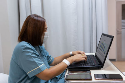 Side view of woman using mobile phone