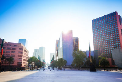 Modern buildings in city against clear sky