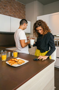 Young couple sitting on table at home