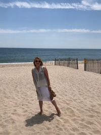 Full length of woman standing at beach