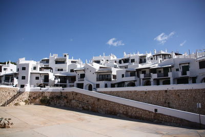 Residential buildings against sky on sunny day