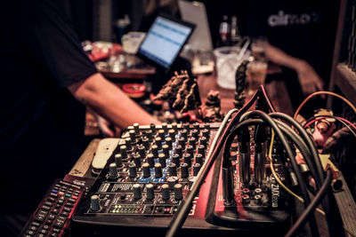 Midsection of man using sound mixer