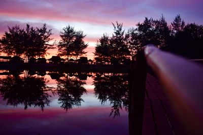 Scenic view of lake against sky at sunset