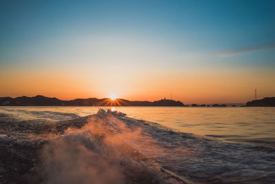 Scenic view of sea against clear sky during sunset