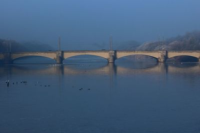 Bridge over river against blue sky