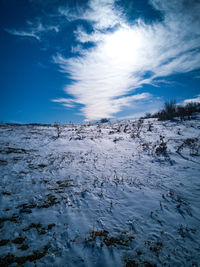 Scenic view of snowcapped landscape against blue sky