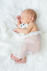 Cute baby girl sleeping on bed