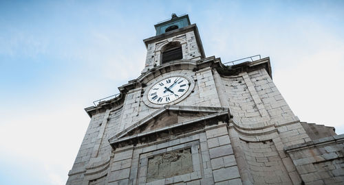 Low angle view of clock tower against sky