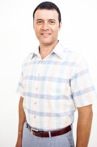 Portrait of smiling mid adult man against white background