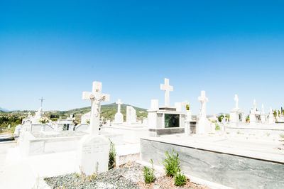 View of cemetery against clear blue sky