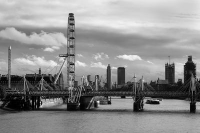 View of bridge over river against cloudy sky