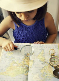 High angle view of girl wearing hat on table