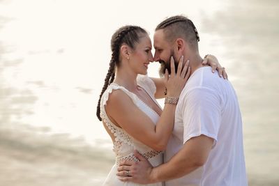 Couple kissing against blurred background