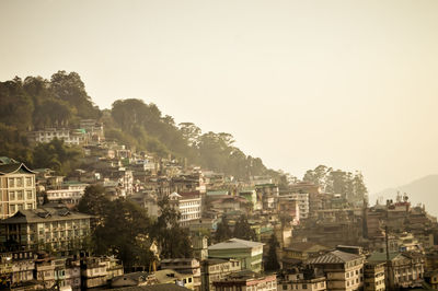 Buildings in city against clear sky