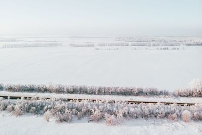 Scenic view of snow covered land against sky
