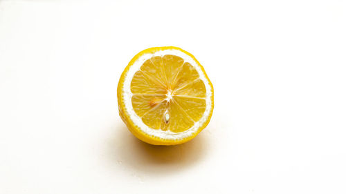 Close-up of lemon slice over white background