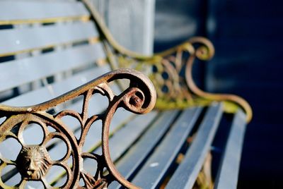 Close-up side view of a empty bench