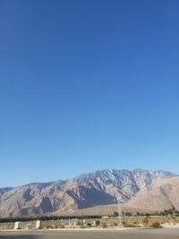 Scenic view of mountains against clear blue sky