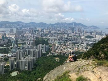 High angle view of woman sitting amidst buildings in city