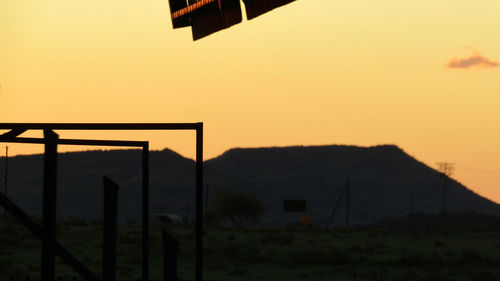 Scenic view of silhouette field against sky during sunset