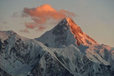 Scenic view of snowcapped mountains against sky during sunset