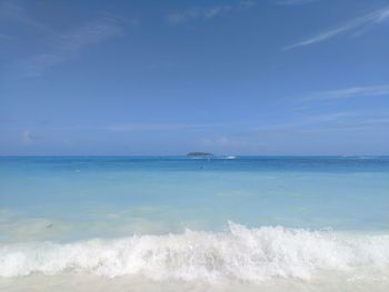 Scenic view of sea against blue sky