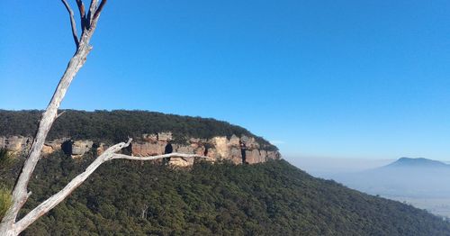 Scenic view of mountain against blue sky