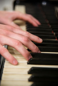 Cropped image of musician playing piano