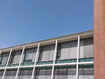 Low angle view of building against clear blue sky