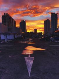 Modern buildings against sky during sunset in city