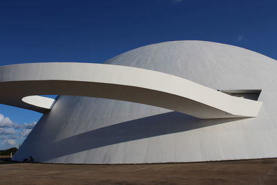 Low angle view of modern building against blue sky