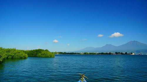 Scenic view of lake against blue sky