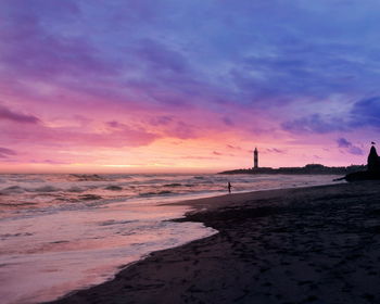 Scenic view of beach against sky during sunset