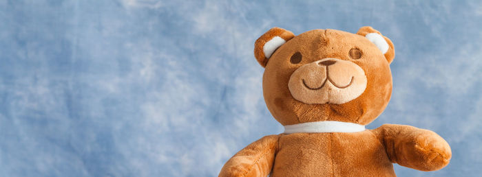 Low angle view of brown teddy bear against sky