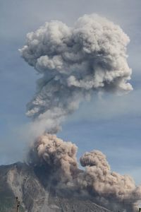 Smoke emitting from volcanic mountain against sky