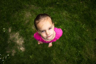 Portrait of cute boy lying on grass