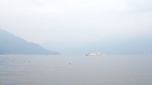 Boat sailing on sea against sky