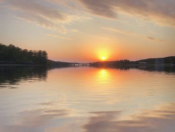 Scenic view of lake against orange sky