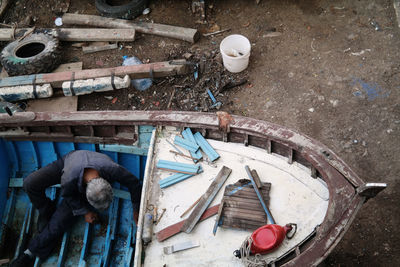 High angle view of worker working on boat