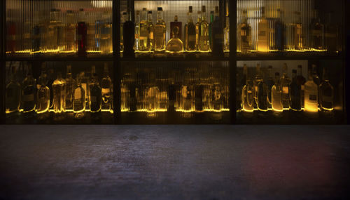 View of glass bottles on table at night